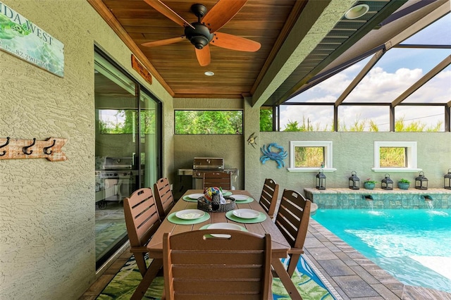 sunroom featuring ceiling fan and wooden ceiling