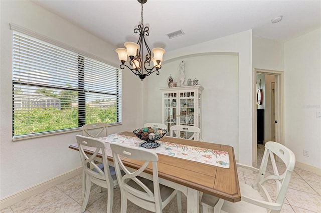 dining area featuring a notable chandelier and light tile patterned floors