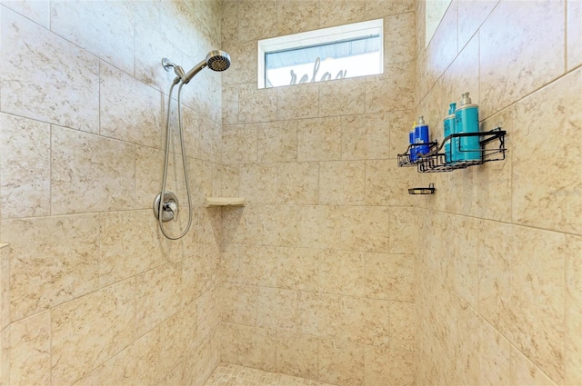 bathroom with a tile shower