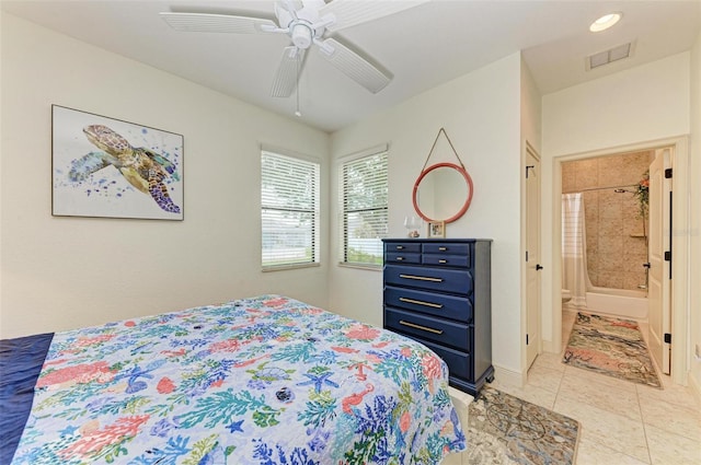 tiled bedroom featuring connected bathroom and ceiling fan