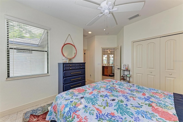 bedroom with ceiling fan, a closet, and multiple windows