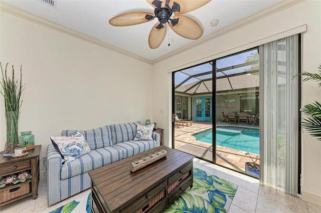 living room featuring ceiling fan, ornamental molding, and light tile patterned floors