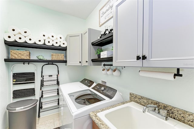 laundry area featuring cabinets, sink, and independent washer and dryer