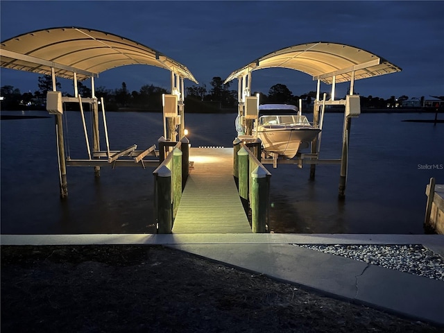 dock area with a water view and boat lift