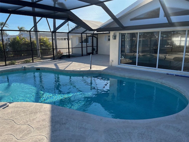 outdoor pool featuring a patio and glass enclosure