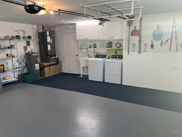 garage with heating unit, washing machine and dryer, electric water heater, and a garage door opener