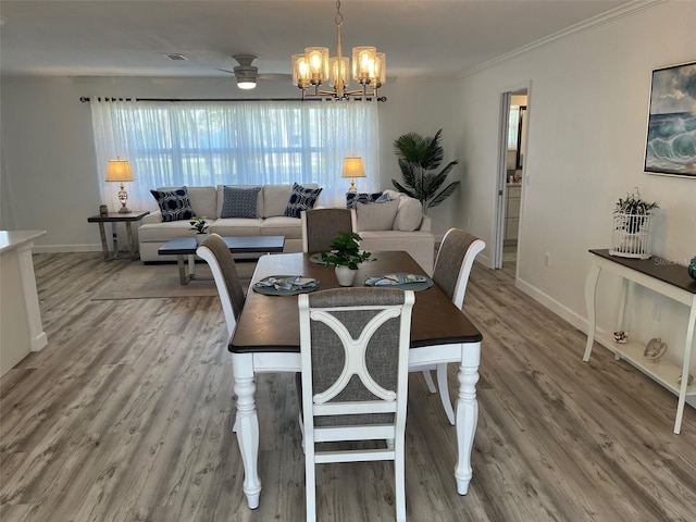 dining space with plenty of natural light, wood finished floors, and baseboards