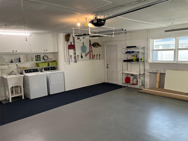 garage featuring a sink, washer and dryer, and a garage door opener