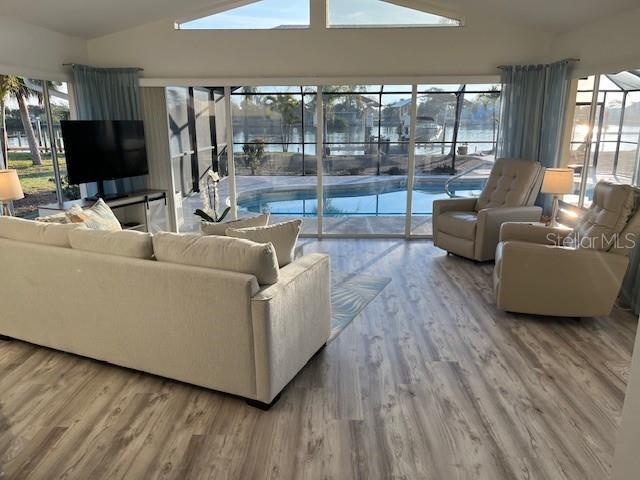 living room featuring vaulted ceiling and wood finished floors