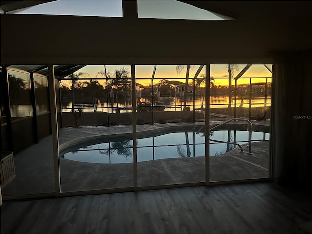 outdoor pool with glass enclosure and a patio