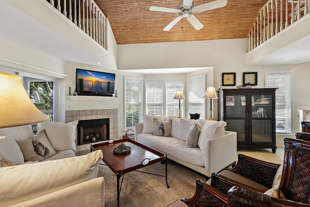 living room with plenty of natural light, a high ceiling, and wooden ceiling