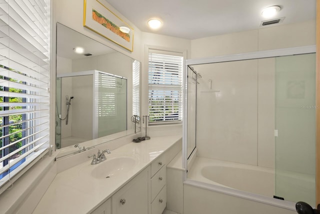 bathroom featuring vanity and shower with separate bathtub