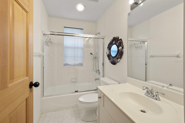 full bathroom with toilet, vanity, and bath / shower combo with glass door