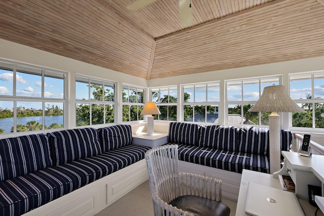 sunroom / solarium with a water view, lofted ceiling, and wooden ceiling