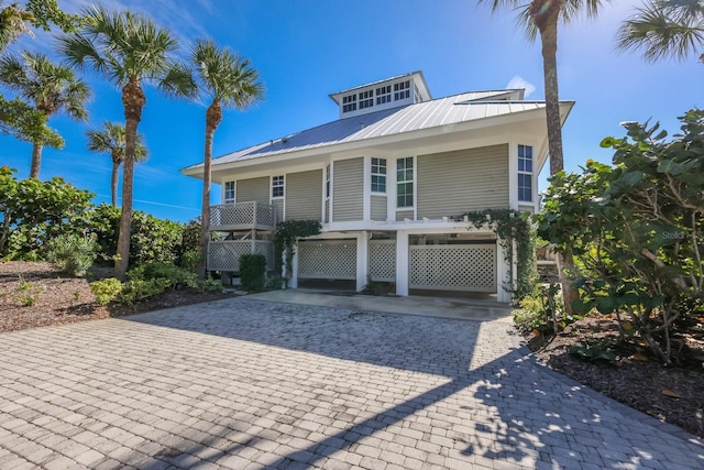 coastal home with a carport and a balcony