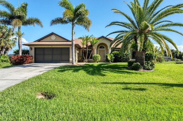 view of front of house with a garage and a front lawn