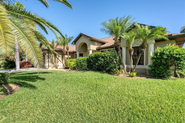 mediterranean / spanish-style house featuring a front lawn