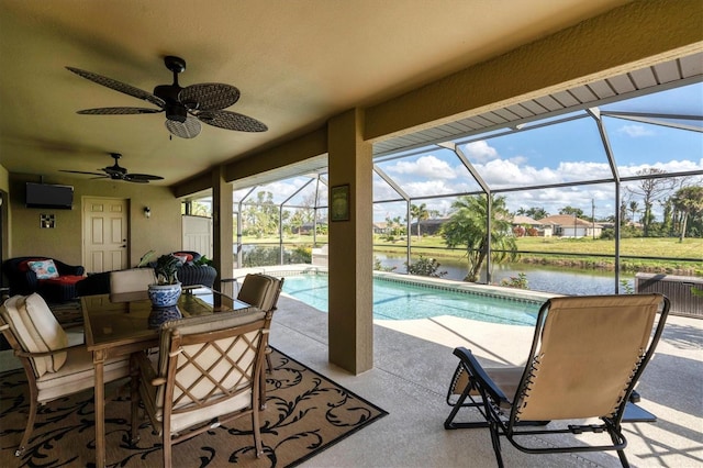 sunroom / solarium featuring a water view