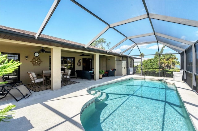 view of pool featuring ceiling fan, a lanai, and a patio area