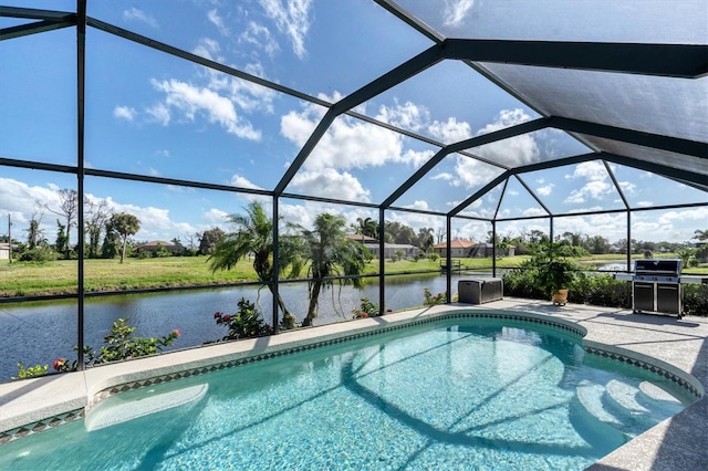 view of pool with a water view, area for grilling, a lanai, and a patio