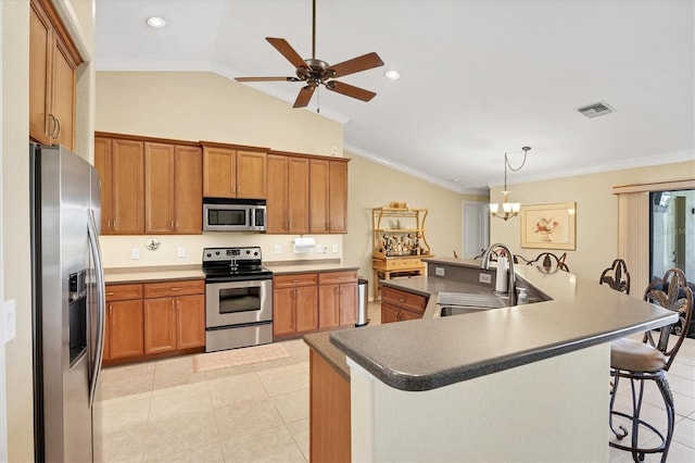 39 Tournament Rd, Rotonda West, FL 33947 - kitchen featuring stainless steel appliances, a sink, vaulted ceiling, brown cabinets, and a ceiling fan
