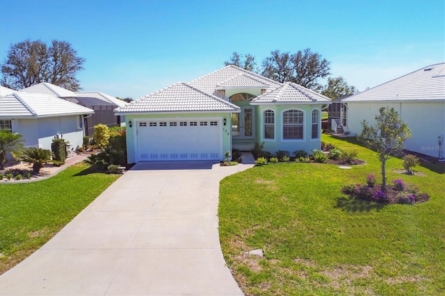 mediterranean / spanish-style home featuring a garage and a front yard