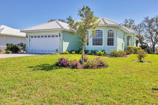 view of front facade with a garage and a front yard