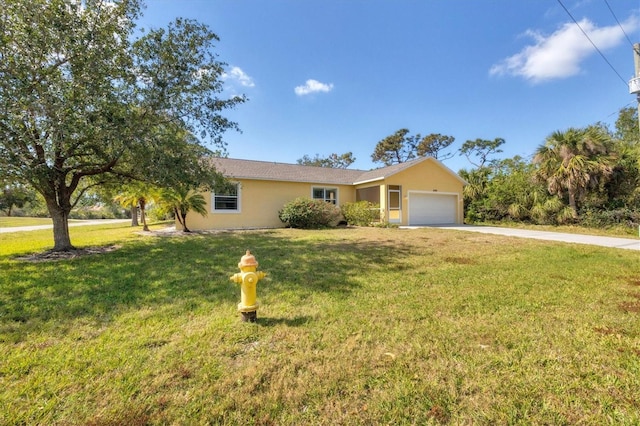 single story home featuring a garage and a front yard