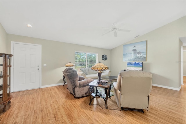 living room with ceiling fan, lofted ceiling, and light hardwood / wood-style floors