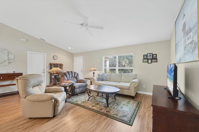 living room featuring vaulted ceiling, ceiling fan, and light wood-type flooring