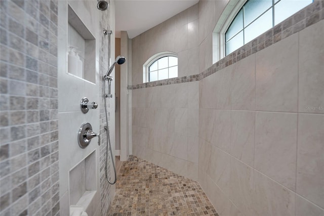 bathroom with a tile shower