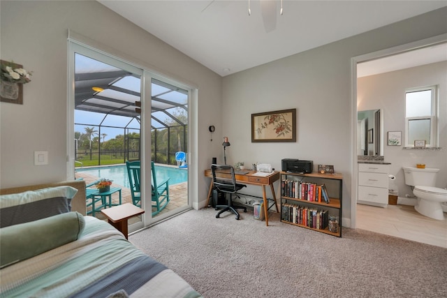 carpeted office space featuring ceiling fan