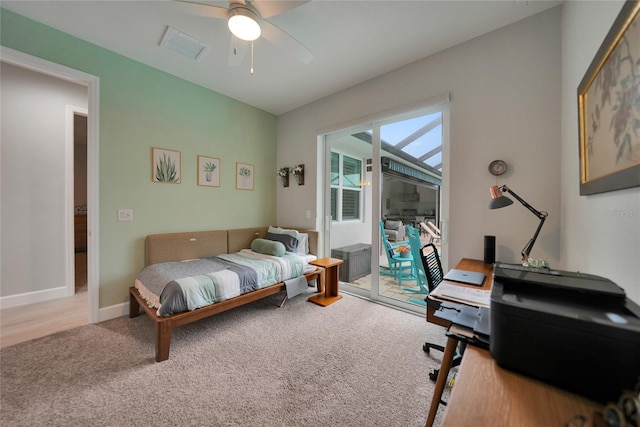 bedroom with light carpet, access to exterior, and ceiling fan