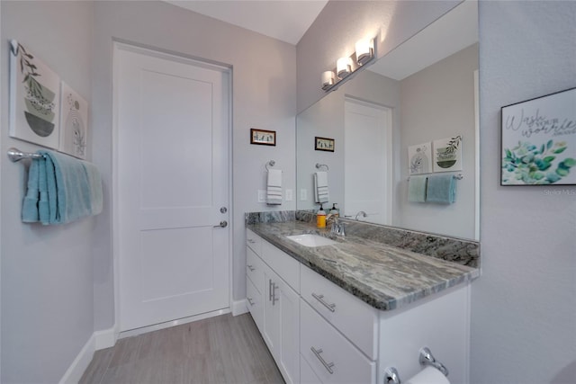 bathroom featuring hardwood / wood-style flooring and vanity