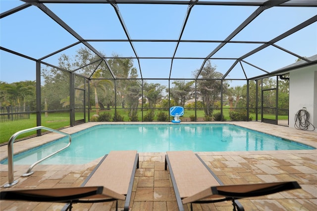 view of pool with a patio area and glass enclosure