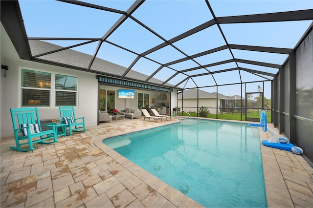 view of swimming pool featuring a lanai, a patio area, and outdoor lounge area