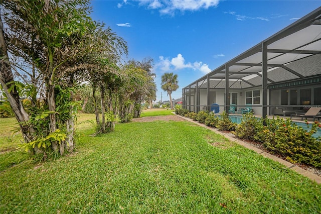 view of yard with a pool and glass enclosure