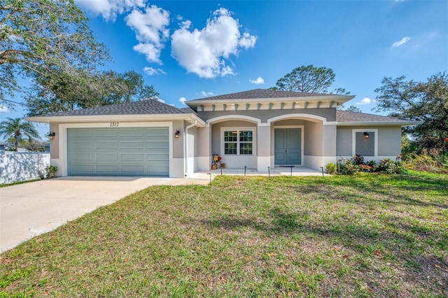 view of front of property with a garage and a front yard