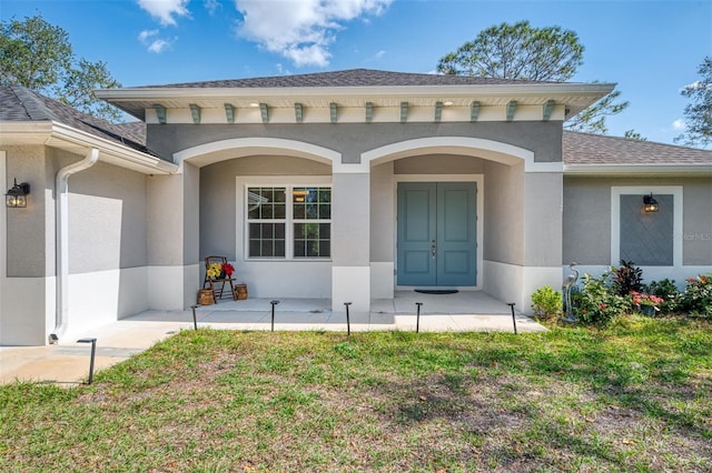 entrance to property with a yard