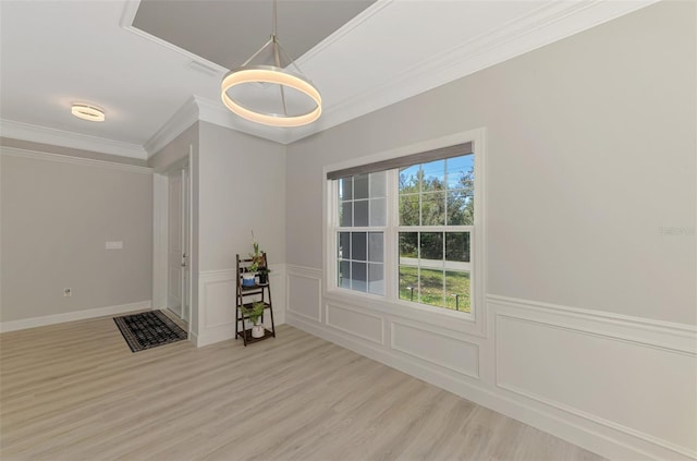 unfurnished dining area featuring crown molding and light hardwood / wood-style floors