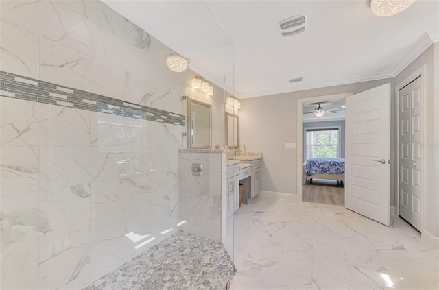 bathroom with ornamental molding, vanity, and a tile shower