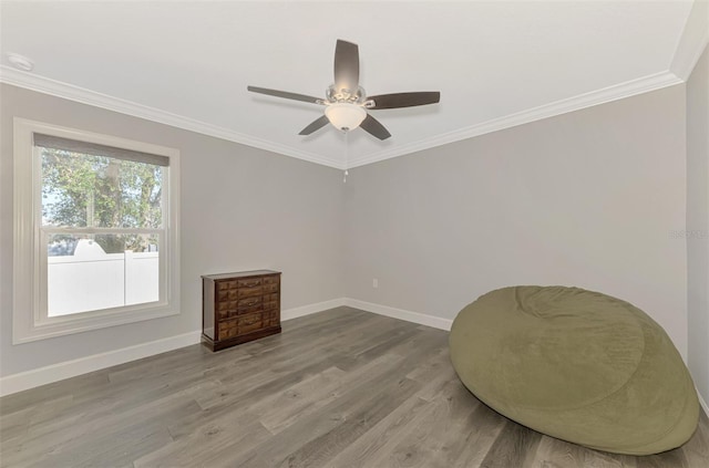 sitting room featuring crown molding, ceiling fan, and light wood-type flooring