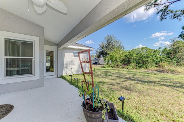 view of yard with ceiling fan and a patio area