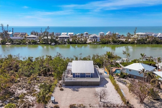 drone / aerial view with a water view and a residential view