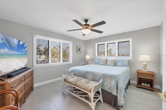 bedroom with ceiling fan, light tile patterned flooring, and baseboards