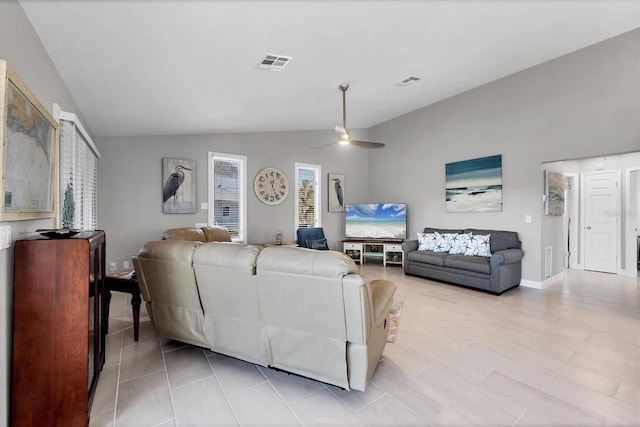 living area with lofted ceiling, visible vents, and a ceiling fan