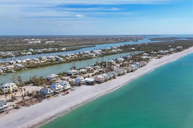 aerial view with a water view and a beach view