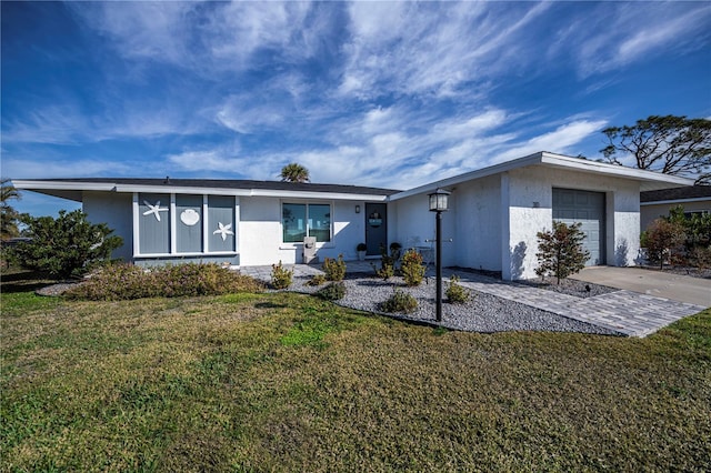 view of front of property with a garage and a front yard