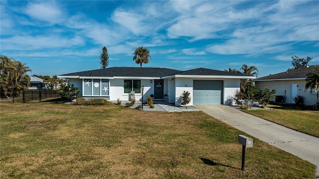 ranch-style home with a garage and a front yard