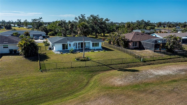 view of front of house featuring a lanai and a front lawn